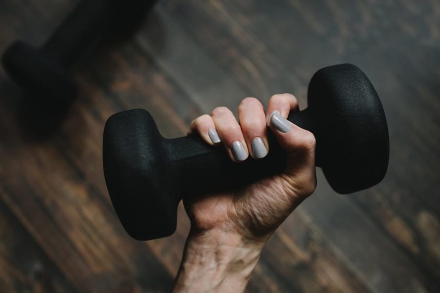 person-holding-black-dumbbell